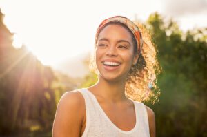 A young woman smiling confidently with restored teeth.