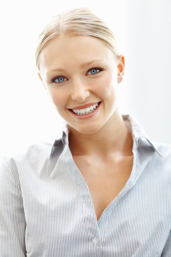 A young woman smiling after professional teeth whitening in Addison.