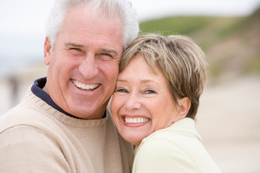 A smiling older couple happy from dental restoration in Addison.