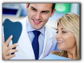 A dentist and patient evaluating cosmetic bonding results in Addison.